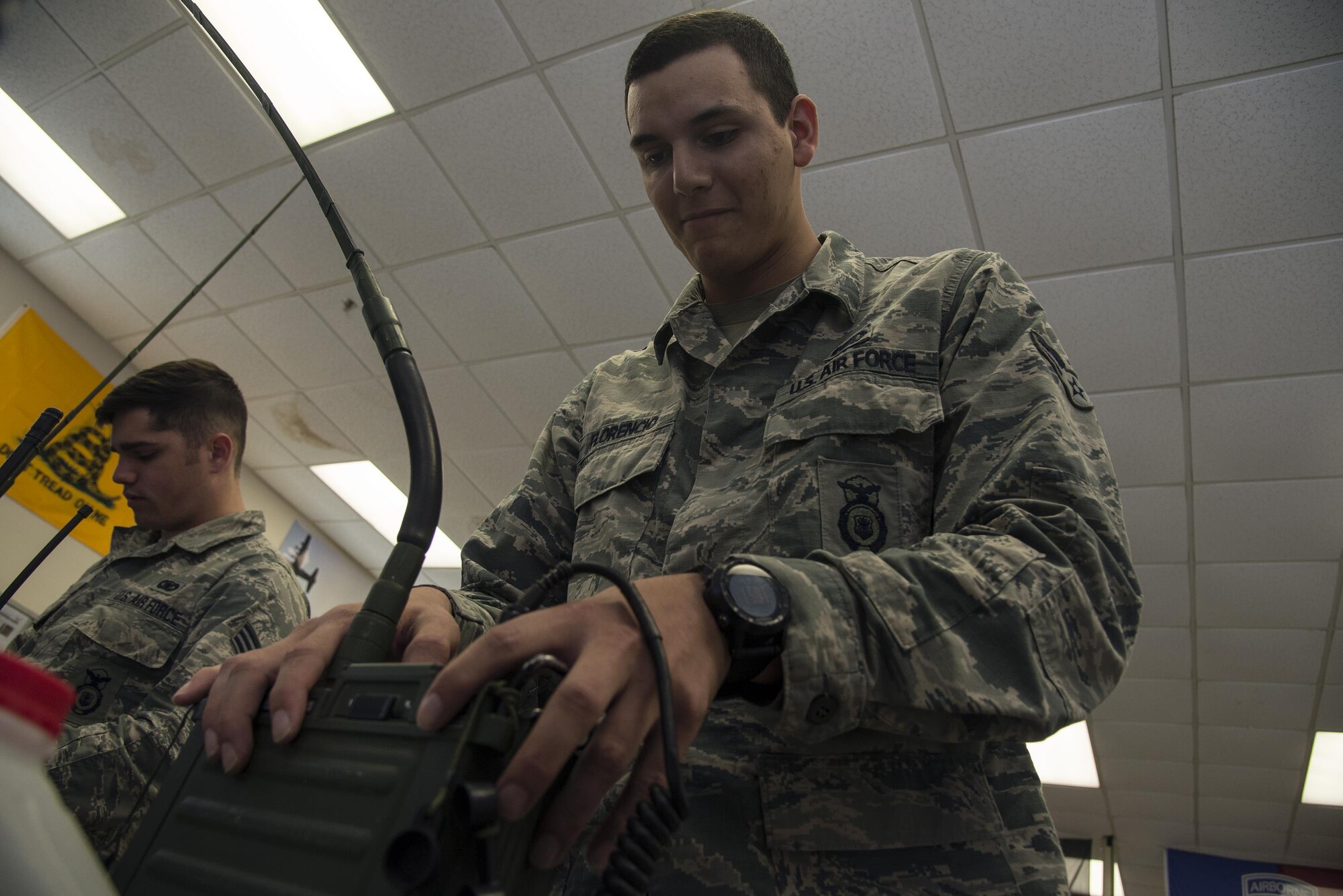 U.S. Air Force Airman 1st Class Elliot Florencio, 823d Base Defense Squadron fire team member, programs a portable radio in preparation for an upcoming training exercise, March 2, 2016 at Moody Air Force Base, Ga. The flight broke into two teams and took turns programming radios to ensure the team can communicate with leadership while in the field. (U.S. Air Force photo by Airman 1st Class Janiqua P. Robinson/Released)