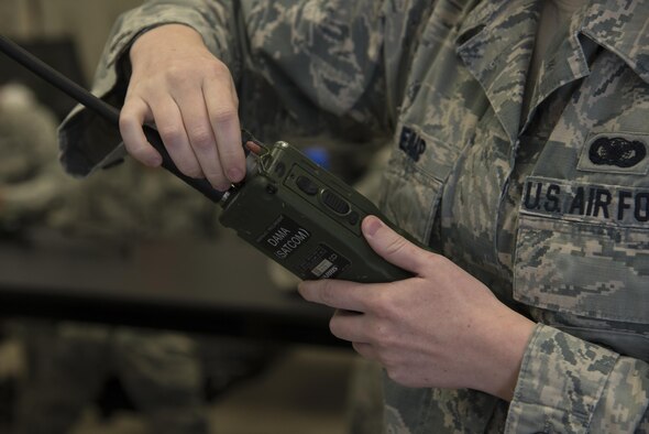 U.S. Air Force Senior Airman Morgan Earp, 823d Base Defense Squadron fire team member, programs a handheld radio in preparation for an upcoming training exercise, March 2, 2016, at Moody Air Force Base, Ga. The 823d BDS trains regularly to maintain readiness to become part of the Global Response Force, which is tasked to be ready for any mission, anywhere within 72-hours of notification.
(U.S. Air Force photo by Airman 1st Class Janiqua P. Robinson/Released)