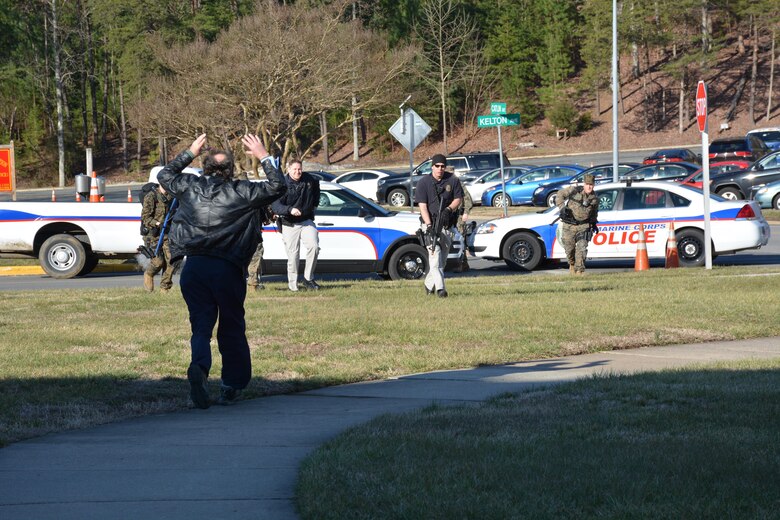 A "witness" runs toward arriving first responders during an Active Shooter exercise at Lejeune Hall.