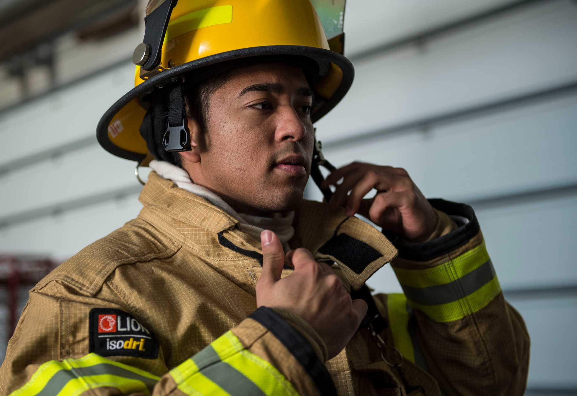 Senior Airman Derrick Kemp, a 424th Air Base Squadron firefighter, inspects his gear at Chièvres Air Base, Belgium, Feb. 25, 2016. Kemp is one of 70 Airmen stationed at the 424th ABS that provides airfield operations support for the base. (U.S. Air Force photo/Staff Sgt. Sara Keller)