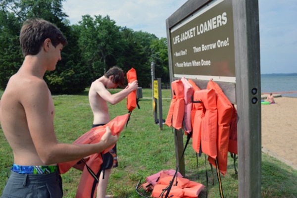Two young swimmers place life vests from the Life Jacket Loaner board at the Cheatham Dam beach area in Ashland City, Tennessee. Every year thousands of people in the United States mourn the loss of loved ones who could have survived if they had been wearing a life jacket while spending time on or near our nation’s waters. To heighten awareness, the U.S. Army Corps of Engineers recently launched a national water safety campaign titled “Life Jackets Worn - Nobody Mourns.