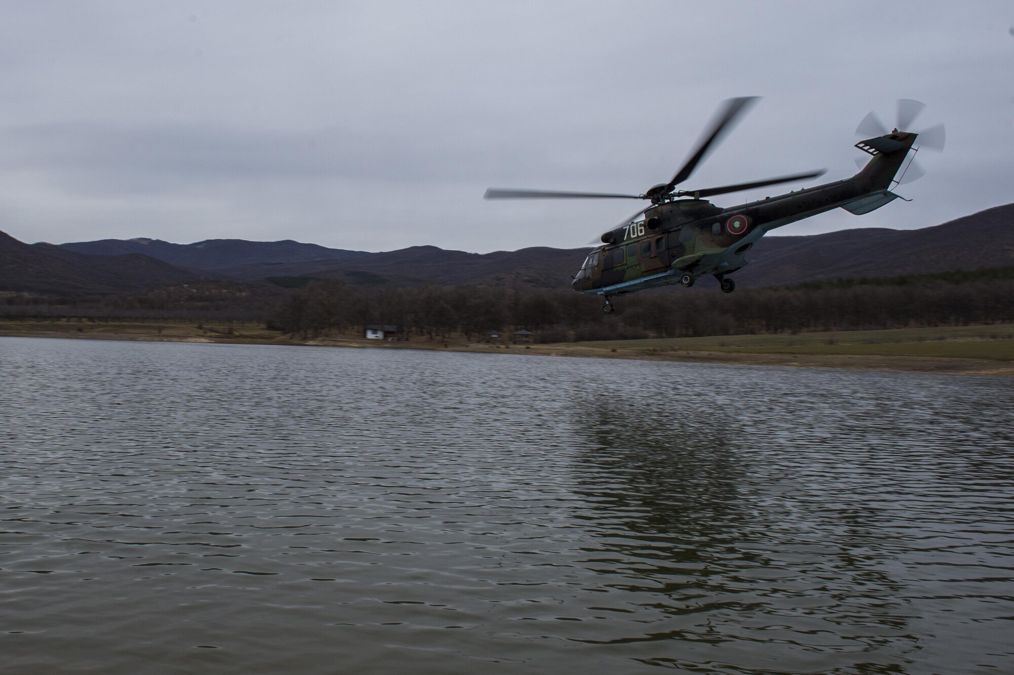 PLOVDIV, Bulgaria - A Bulgarian Cougar military helicopter flies over a body of water during combat search and rescue training near Plovdiv, Bulgaria, Feb. 11, 2016. The helicopter was protected by 74th Expeditionary Fighter Squadron A-10C Thunderbolt II aircraft during the training. (U.S. Air Force photo by Airman 1st Class Luke Kitterman/Released)
