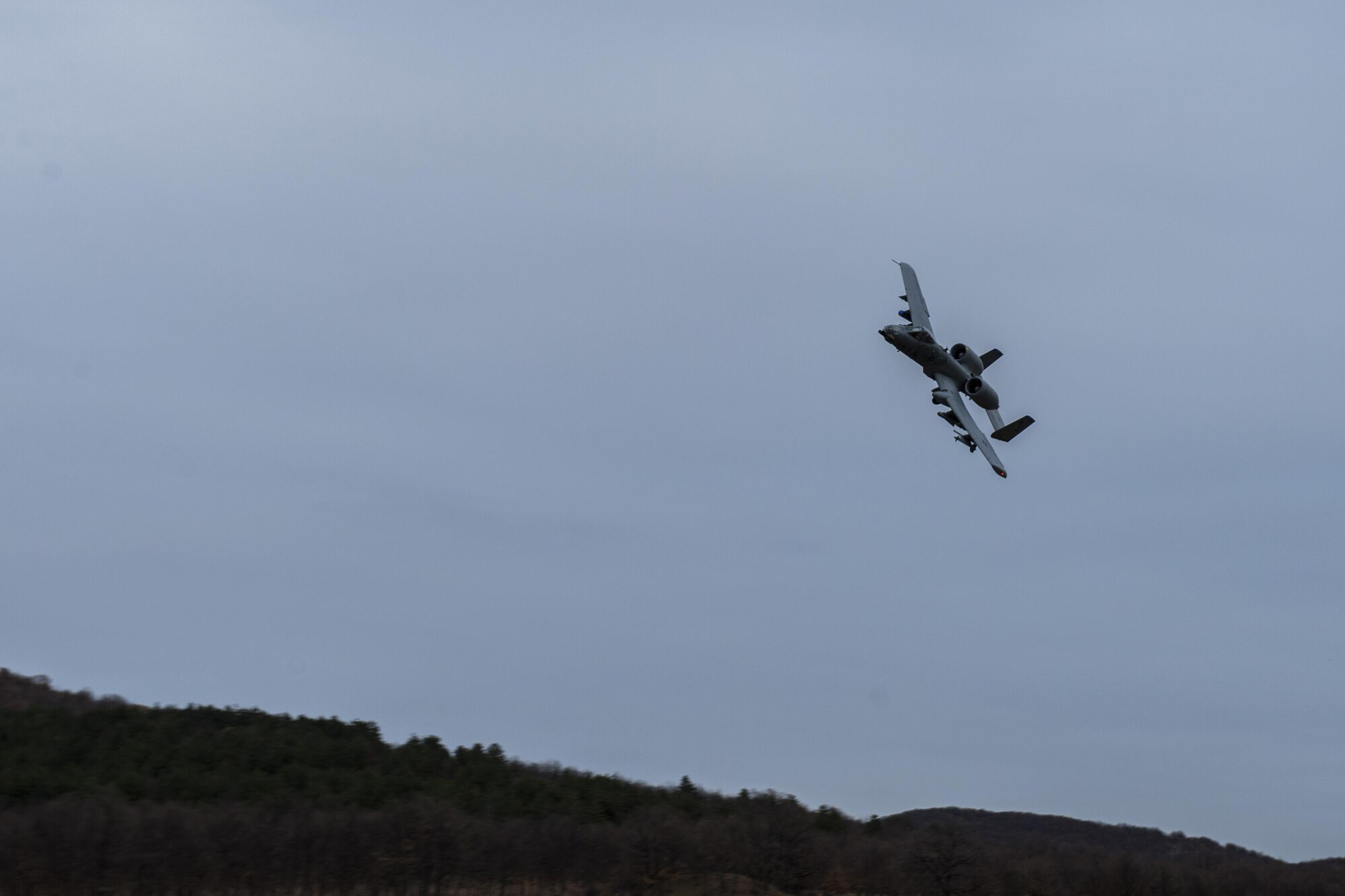 PLOVDIV, Bulgaria - A 74th Expeditionary Fighter Squadron A-10C Thunderbolt II aircraft soars through the air during combat search and rescue training near Plovdiv, Bulgaria, Feb. 11, 2016. The aircraft provided close air support for a survivor on the ground. (U.S. Air Force photo by Airman 1st Class Luke Kitterman/Released)