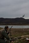 PLOVDIV, Bulgaria - Italian air force Captain Roberto Manzo, a 74th Expeditionary Fighter Squadron A-10C Thunderbolt II aircraft exchange pilot, communicates with an A-10 flying close by during combat search and rescue training near Plovdiv, Bulgaria, Feb. 11, 2016. Manzo reported his location, current health status and possible threats in the surrounding area during the training simulation. (U.S. Air Force photo by Airman 1st Class Luke Kitterman/Released)