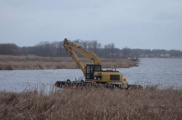 The arrival of a pontoon excavator to the Braddock Bay Ecosystem Restoration Project will allow the project to continue on-schedule despite unseasonably wet conditions.