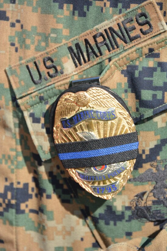 Marine Corps Base Quantico Military Police display the traditional symbol of mourning when a fellow officer has fallen.

Mourning Band: Quantico Honors Marine Reservist, Prince William County Police Officer Ashley M. Guindon, who was Gunned Down in the Line of Duty, Feb. 27.