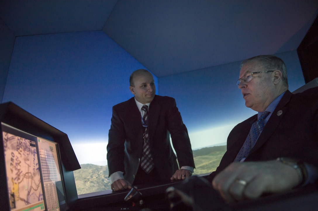 Deputy Defense Secretary Bob Work operates a flight simulator during his visit to Wright-Patterson Air Force Base, Ohio, in support of the White House’s Week at the Labs initiative, March 3, 2016. Work also toured the base and spoke to students from the Dayton, Ohio, area during his visit. DoD photo by Air Force Senior Master Sgt. Adrian Cadiz