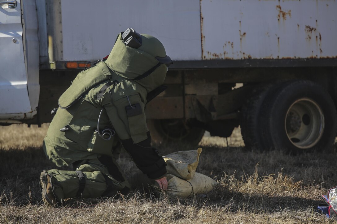 A Marine with  Explosive Ordnance Disposal Platoon, Combat Logistics Battalion 2, places a sandbag during a field exercise at Camp Lejeune, N.C., March 2, 2016. Marines used equipment such as compact metal detectors, bomb suits and a TALON robot to locate and handle ordnance, which took the form of a simulated IED, ammunition or artillery shell. (U.S. Marine Corps photo by Cpl. Paul S. Martinez/Released)