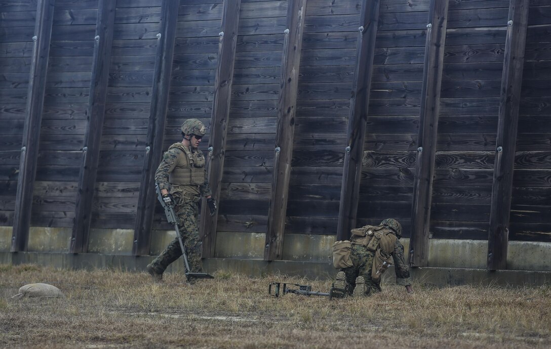 Marines with Explosive Ordnance Disposal  Platoon, Combat Logistics Battalion 2, utilize a compact metal detector to sweep for improvised explosive devices during a field exercise at Camp Lejeune, N.C., March 2, 2016. Marines utilized equipment such as compact metal detectors, bomb suits and a  TALON robot to locate and handle ordnance, which took the form of a simulated IED, ammunition or artillery shell. (U.S. Marine Corps photo by Cpl. Paul S. Martinez/Released)