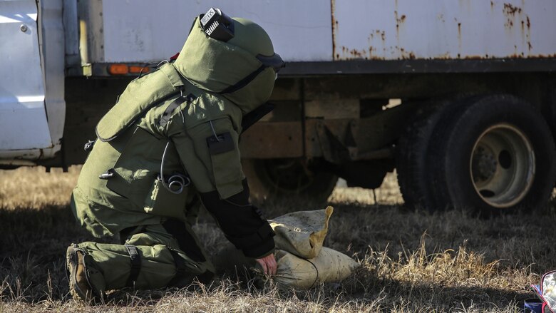 A Marine with  Explosive Ordnance Disposal Platoon, Combat Logistics Battalion 2, places a sandbag during a field exercise at Marine Corps Base Camp Lejeune, N.C., March 2, 2016. Marines used equipment such as compact metal detectors, bomb suits and a TALON robot to locate and handle ordnance, which took the form of a simulated IED, ammunition or artillery shell.