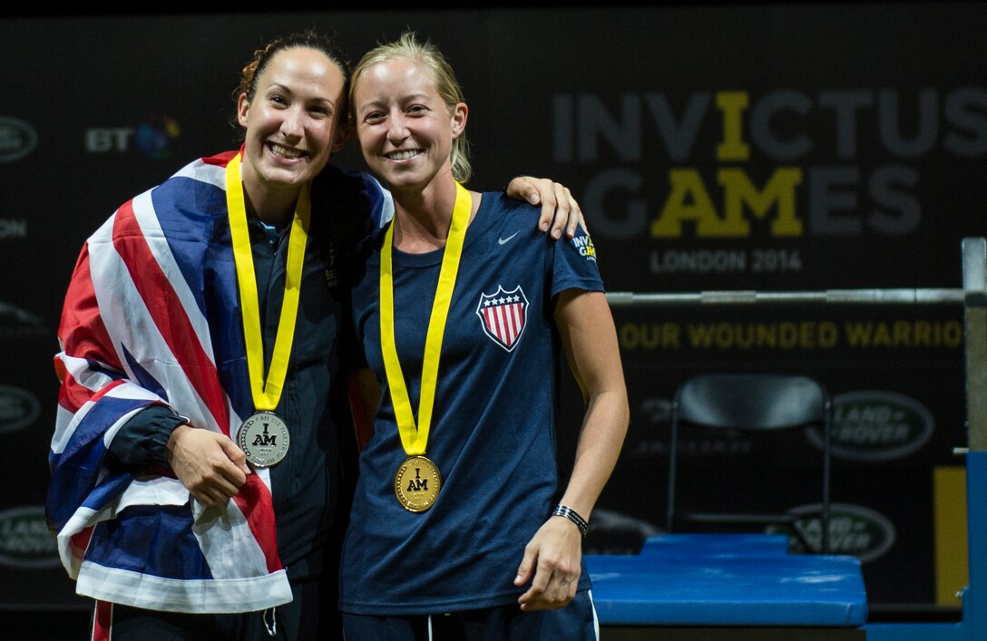 U.S. Marine Corps Sgt. Lakin Booker, right, the gold medalist in the women's lightweight powerlifting event, and British Royal Navy weapons engineer Mickaela Richards, the silver medalist, pose for a photo during the 2014 Invictus Games at Queen Elizabeth Olympic Park in London, Sept. 14, 2014. U.S. Air Force photo by Senior Airman Justyn Freeman 