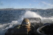 An Amphibious Assault Vehicle operator breaks through the waves as he pilots toward the beaches of Camp Pendleton Feb. 24, 2016. Marines began their Marine Corps Combat Readiness Evaluation, which tested the readiness of the Marines of Company A, 3rd Assault Amphibian Battalion prior to their upcoming deployment to Okinawa, Japan. (U.S. Marine Corps photo by Lance Cpl. Timothy Valero/ Released)