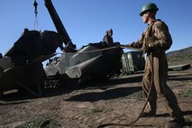 A Marine removes a heavily armored engine cover from an Amphibious Assault Vehicle in order to conduct maintenance on the engine during a Marine Corps Combat Readiness Evaluation Feb. 24, 2016. The MCCRE evaluates the readiness of the Marines of Company A, 3rd Assault Amphibian Battalion prior to their deployment to Okinawa, Japan. Marines in the maintenance section are also tested during the MCCRE along with the AAV-7 crew. (U.S. Marine Corps photo by Lance Cpl. Timothy Valero/ Released)