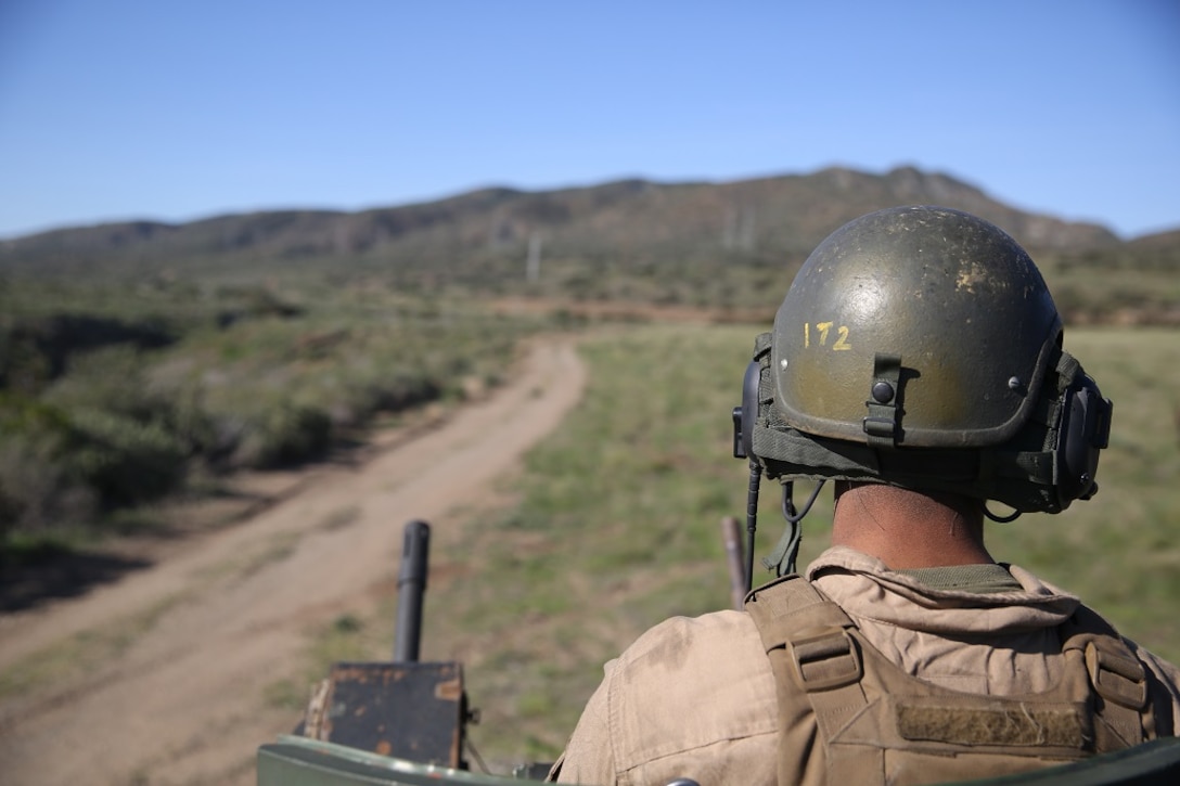 An Amphibious Assault Vehicle crewman scans the area for enemy activity during a Marine Corps Combat Readiness Evaluation Feb. 25, 2016. The MCCRE evaluates the readiness of the Marines of Company A, 3rd Assault Amphibian Battalion prior to their deployment to Okinawa, Japan. (U.S. Marine Corps photo by Lance Cpl. Timothy Valero/ Released)