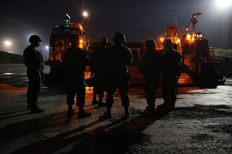 Marines wait to board a Landing Craft Air Cushion to transport to the USS Essex (LHD 2) off the shore of Camp Pendleton Feb. 22, 2016. The Marines prepared to start a week-long Marine Corps Combat Readiness Evaluation to ensure the unit is ready for an upcoming deployment. The Marines are with Company A, 3rd Assault Amphibian Battalion, 1st Marine Division. (U.S. Marine Corps photo by Lance Cpl. Timothy Valero/Released)