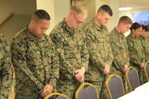 Students of a Chemical Biological Incident Response Force (CBIRF) Command Sponsored Corporals Course bow their heads in prayer during a Mess Night at the Mix House aboard Naval Support Facility Indian Head, Md., Feb. 25, 2016. Corporals with CBIRF, U.S. Marine Forces Command (MARFORCOM), participated in the time-honored tradition of a Marine Corps Mess night with guest of honor Sgt. Maj. Robert G. VanOostrom, sergeant major of manpower and reserve affairs, the night prior to their graduation from the course. The noncommissioned officers completed the 3 week course curriculum that included sword and guidon manual, land navigation, Marine Corps promotion system for sergeants and below and other small unit leader skills and traits. (Official USMC Photos by Sgt. Santiago G. Colon Jr./Released)