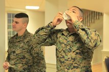 Lexington, Md.- native Cpl. Bryce C. Ware, a response Marine with Identification and Detection Platoon, Reaction Force Company, Chemical Biological Incident Response Force (CBIRF), drinks from the “grog” during a Mess Night at the Mix House aboard Naval Support Facility Indian Head, Md., Feb. 25, 2016. Corporals with CBIRF, U.S. Marine Forces Command (MARFORCOM), participated in the time-honored tradition of a Marine Corps Mess night with guest of honor Sgt. Maj. Robert G. VanOostrom, sergeant major of manpower and reserve affairs, the night prior to their graduation from the course. The noncommissioned officers completed the 3 week course curriculum that included sword and guidon manual, land navigation, Marine Corps promotion system for sergeants and below and other small unit leader skills and traits. (Official USMC Photos by Sgt. Santiago G. Colon Jr./Released)
