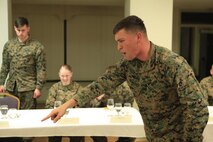 Plant City, Fla.- native Cpl. Justin A. Howard, a team member with Technical Rescue Platoon, React Force Company, Chemical Biological Incident Response Force (CBIRF), impersonates an instructor as part of a skit during a Mess Night at the Mix House aboard Naval Support Facility Indian Head, Md., Feb. 25, 2016. Corporals with CBIRF, U.S. Marine Forces Command (MARFORCOM), participated in the time-honored tradition of a Marine Corps Mess night with guest of honor Sgt. Maj. Robert G. VanOostrom, sergeant major of manpower and reserve affairs, the night prior to their graduation from the course. The noncommissioned officers completed the 3 week course curriculum that included sword and guidon manual, land navigation, Marine Corps promotion system for sergeants and below and other small unit leader skills and traits. (Official USMC Photos by Sgt. Santiago G. Colon Jr./Released)
