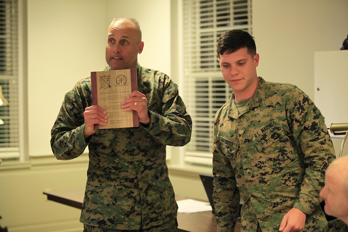 Plant City, Fla.- native Cpl. Justin A. Howard (right), a team member with Technical Rescue Platoon, React Force Company, Chemical Biological Incident Response Force (CBIRF), presents a plaque to guest of honor Sgt. Maj. Robert G. VanOostrom, sergeant major of manpower and reserve affairs, during a Mess Night at the Mix House aboard Naval Support Facility Indian Head, Md., Feb. 25, 2016. Corporals with CBIRF, U.S. Marine Forces Command (MARFORCOM), participated in the time-honored tradition of a Marine Corps Mess Night the night prior to their graduation from the course. The noncommissioned officers completed the 3 week course curriculum that included sword and guidon manual, land navigation, Marine Corps promotion system for sergeants and below and other small unit leader skills and traits. (Official USMC Photos by Sgt. Santiago G. Colon Jr./Released)
