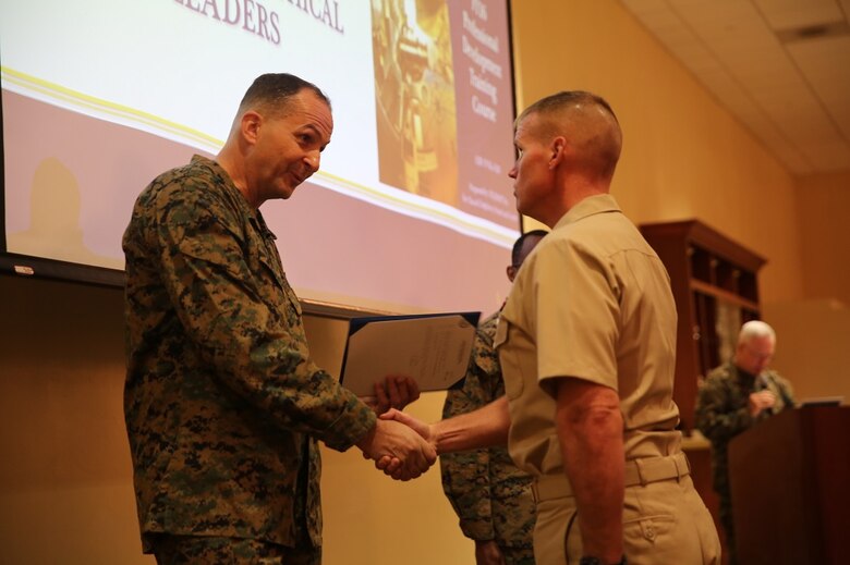 Maj. Gen. Daniel J. O'Donohue presents the Naval Chaplaincy Excellence award to Lt. Michael Kennedy at Camp Pendleton, Feb. 23, 2016. The ceremony recognized Lt. Michael Kennedy and Petty Officer 3rd Class Dawaylon Farr for going above and beyond the call of duty to provide spiritual guidance and renewed faith to Marines and sailors serving I Marine Expeditionary Force. O’Donohue is the commanding general of 1st Marine Division.  Kennedy is a chaplain with 1st Battalion, 1st Marine Regiment, 1st Mar. Div. Farr is a religious program specialist with 1st Bn., 4th Marines. (U.S. Marine Corps photo by Pvt. Robert Bliss/Released)