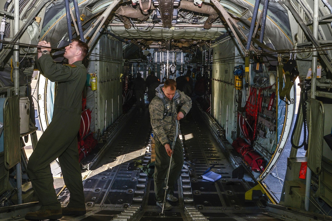 Airmen perform preflight inspections inside an aircraft on Yokota Air Base, Japan, March 2, 2016. The airmen are loadmasters assigned to the 36th Airlift Squadron and responsible for ensuring that aircraft cargo and passengers are transported safely and in a timely manner. Air Force photo by Senior Airman David Owsianka