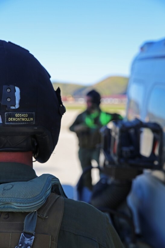 After refueling a UH-1Y Venom, Lance Cpl. Gerald J. Demontmollin III and Staff Sgt. Samuel J. Galan Jr. standby for permission to board the helicopter Feb. 24, 2016, at Camp Pendleton. The aircrewmen performed simulated assault and close air support training to maintain unit readiness. Galan, a native of Houston, Texas, and Demontmollin, from Grass Valley, are crew chiefs with Marine Light Attack Helicopter Squadron 169, Marine Aircraft Group 39, 3rd Marine Air Wing.  (U.S. Marine Corps photo by Lance Cpl. Justin E. Bowles)