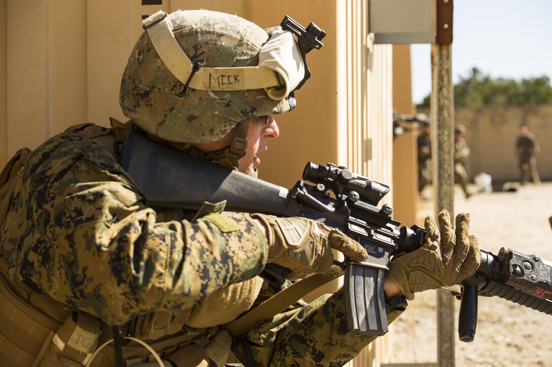 Lance Cpl. Aaron Meek, a military policeman with Bravo Company, 2nd Law Enforcement Battalion, observes a village during Tactical Site Exploitation training at Camp Lejeune, N.C., March 3, 2016. The training allowed 2nd LEB to conduct raids and forensics operations to retain procedures regarding criminal prosecution. (U.S. Marine Corps photo by Lance Cpl. Samuel Guerra/Released)