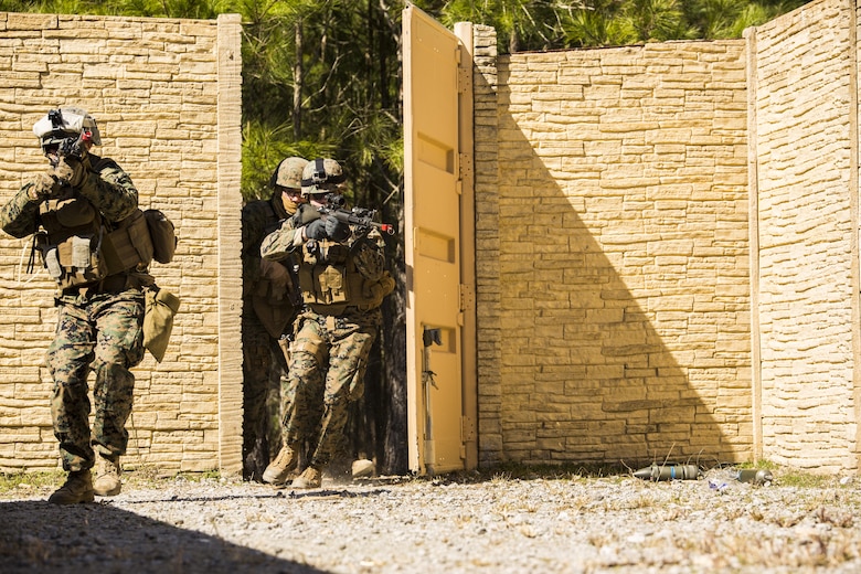 Marines with 2nd Law Enforcement Battalion raid a compound during Tactical Site Exploitation training at Camp Lejeune, N.C., March 3, 2016. The TSE allows military police, intelligence analysts, criminal investigators and forensics experts to work cohesively and properly prosecute enemy suspects. (U.S. Marine Corps photo by Lance Cpl. Samuel Guerra/Released)