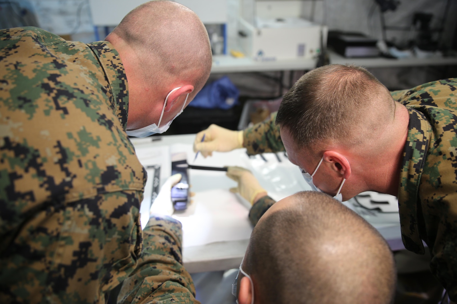 Marines with 2nd Law Enforcement Battalion conduct biometric exploitation during Tactical Site Exploitation training at Camp Lejeune, N.C., March 3, 2016. The unit built their own laboratory on the field to examine fingerprints and other critical pieces of evidence to recognize and assess possible enemy identities. (U.S. Marine Corps photo by Lance Cpl. Samuel Guerra/Released) 