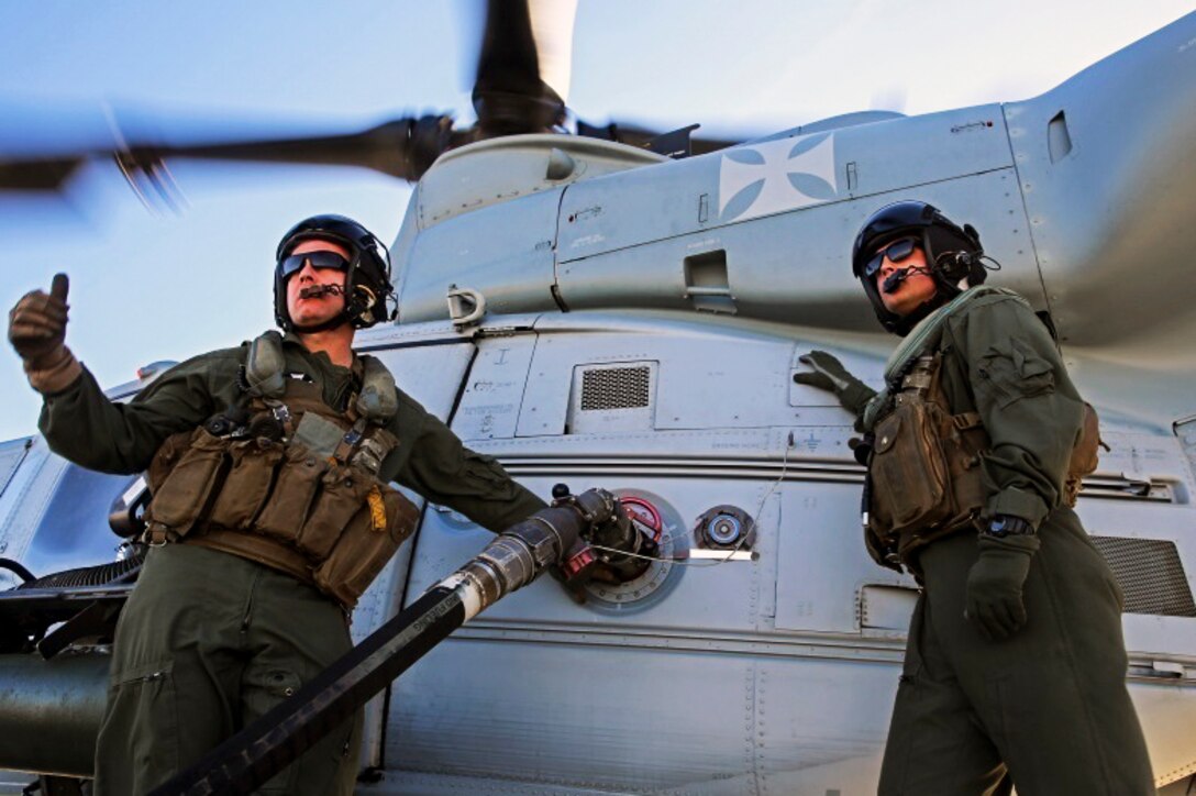 Marine Corps Staff Sgt. Samuel J. Galan Jr. and Lance Cpl. Gerald J. Demontmollin III refuel a UH-1Y Venom before conducting helicopter training on Camp Pendleton, Calif., Feb. 24, 2016. Marine Corps photo by Lance Cpl. Justin E. Bowles