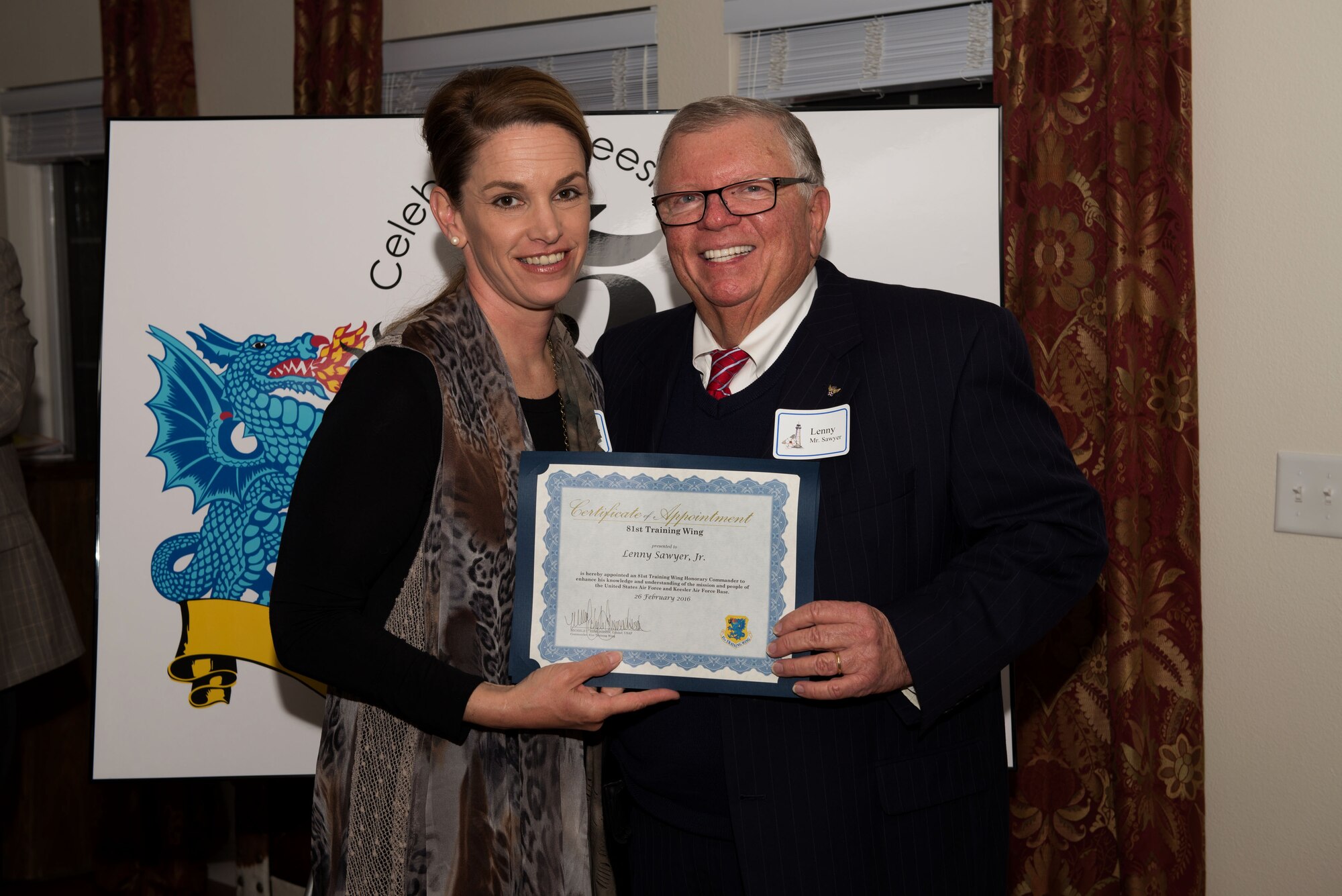 Col. Michele Edmondson, 81st Training Wing commander, presents a certificate to Lenny Sawyer, Jr., during the honorary commander reception and induction ceremony Feb. 26, 2016, Keesler Air Force Base, Miss. Each of the newly appointed honorary commanders received a certificate.