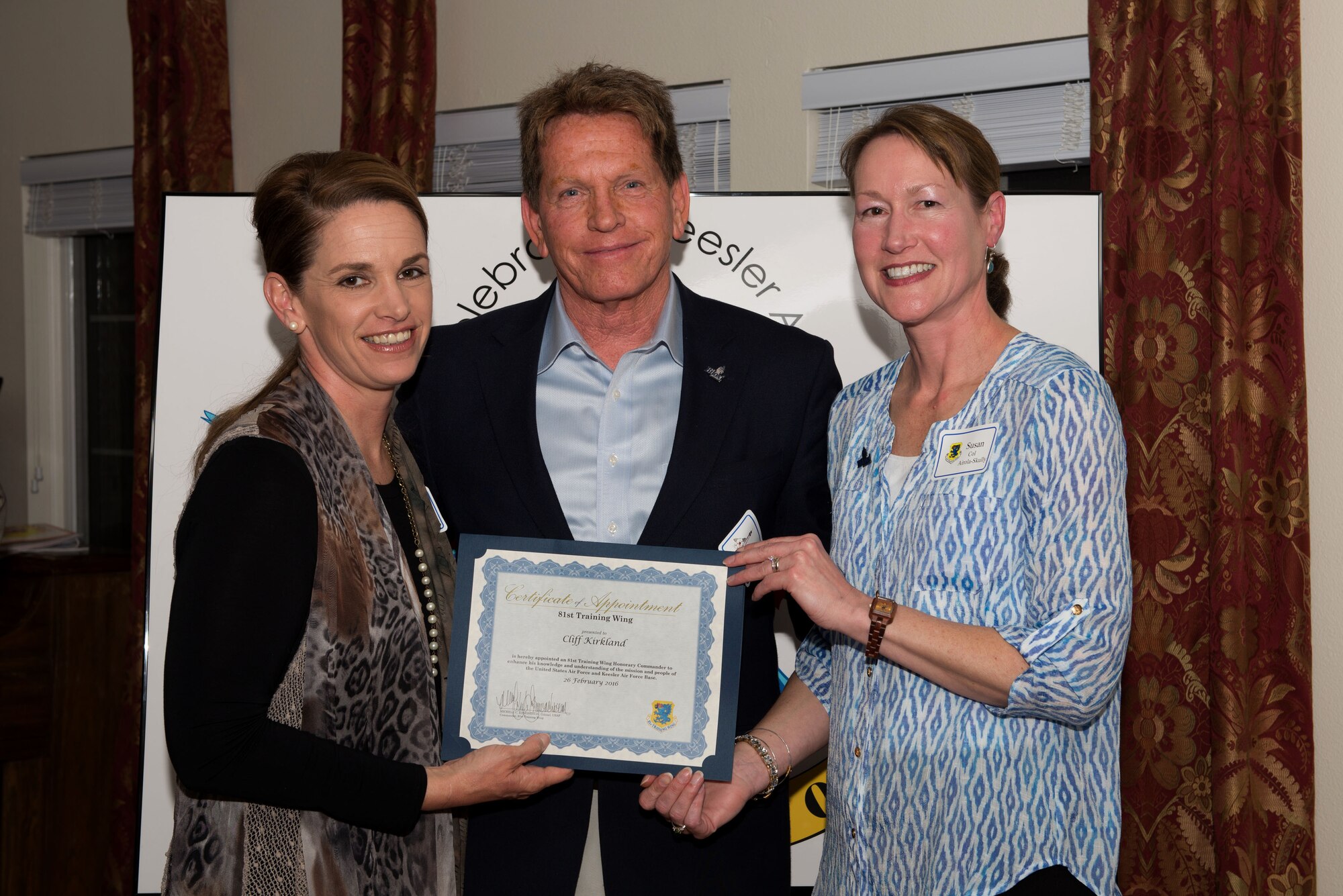 Col. Michele Edmondson, 81st Training Wing commander, presents a certificate to Cliff Kirkland and Col. Susan Airola-Skully, 81st Mission Support Group commander, during the honorary commander reception and induction ceremony Feb. 26, 2016, Keesler Air Force Base, Miss. Each of the newly appointed honorary commanders received a certificate.
