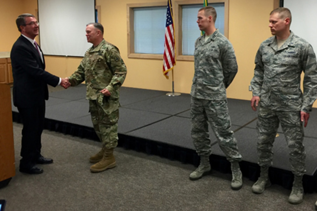 Secretary of Defense Ash Carter with Maj. Gen. Bret D. Daugherty and other service members while visiting the 262nd Network Warfare Squadron.