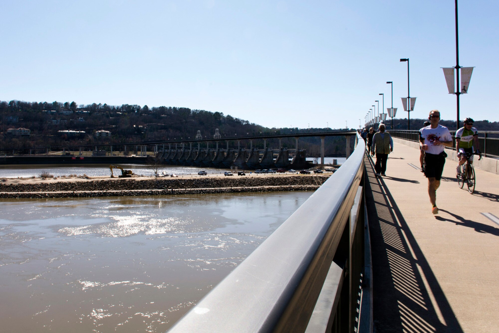 Outdoor enthusiasts in Little Rock, Ark., enjoy the longest purpose-built pedestrian/bicycle bridge in the world Feb. 27, 2016. The bridge, which opened to the public Sept. 30, 2006, rises 90 feet above the river and 30 feet over the dam. The bridge deck is 14 feet wide for two-way traffic, and includes 4,226 lineal feet of bridge and ramps, spanning approximately 3,462 feet of the Arkansas River. (Courtesy photo by Jeff Walston)