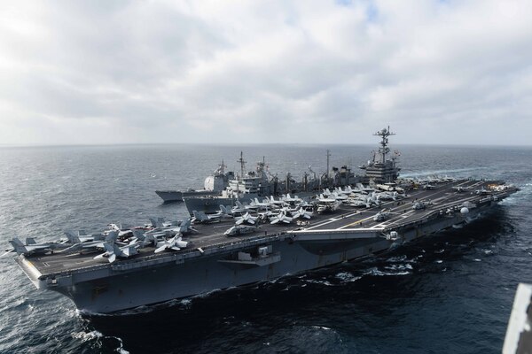 SOUTH CHINA SEA (March 4, 2016) - The aircraft carrier USS John C. Stennis (CVN 74) participates in a replenishment at sea with the fast combat support ship USNS Rainier (T-AOE 7) and the guided-missile cruiser USS Mobile Bay (CG 53). Mobile Bay is receiving an advanced biofuel mixture from Rainier. Providing a ready force supporting security and stability in the Indo-Asia-Pacific, the ships are operating as part of the Great Green Fleet on a regularly scheduled 7th Fleet deployment. 