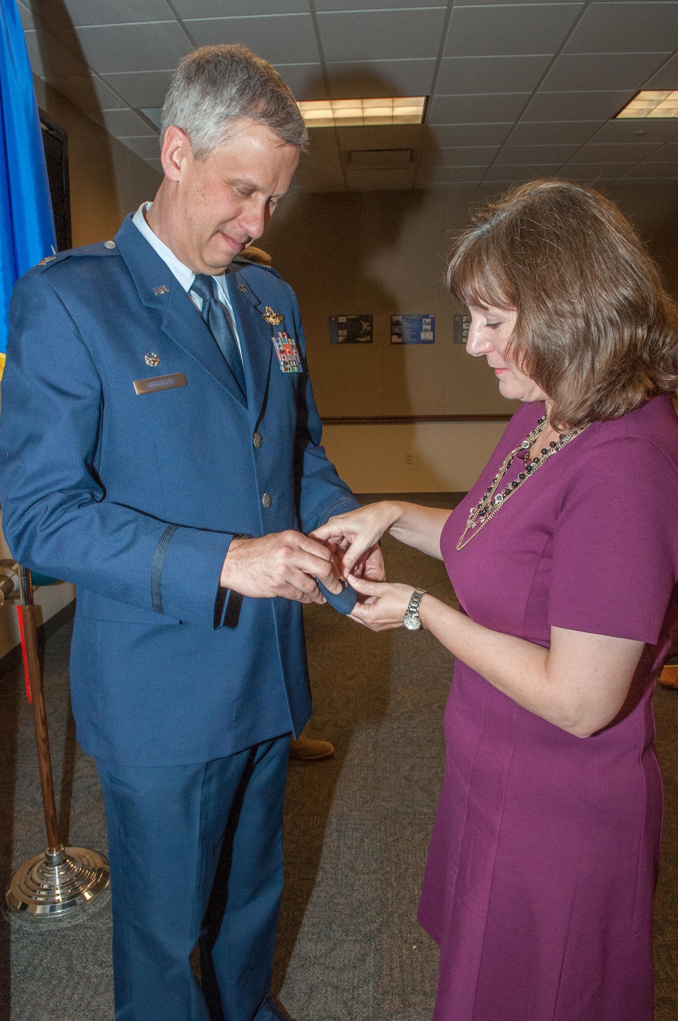 U.S. Air Force Col. Robert Burgess is “pinned” by his wife, Martha, during a promotion ceremony on Barksdale Air Force Base, La. on March 4, 2016. Burgess is the commander of the 307th Operations Group and was recently promoted to the rank of colonel.  (U.S. Air Force photo by Master Sgt. Dachelle Melville/Released)