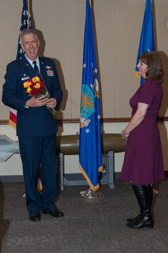 U.S. Air Force Col. Robert Burgess, the commander of the 307th Operations Group, presents his wife, Martha, with roses at his promotion ceremony on Barksdale Air Force Base, La. on March 4, 2016. Burgess is a command pilot with over 5,100 flight hours and was recently promoted to the rank of colonel. (U.S. Air Force photo by Master Sgt. Dachelle Melville/Released)
