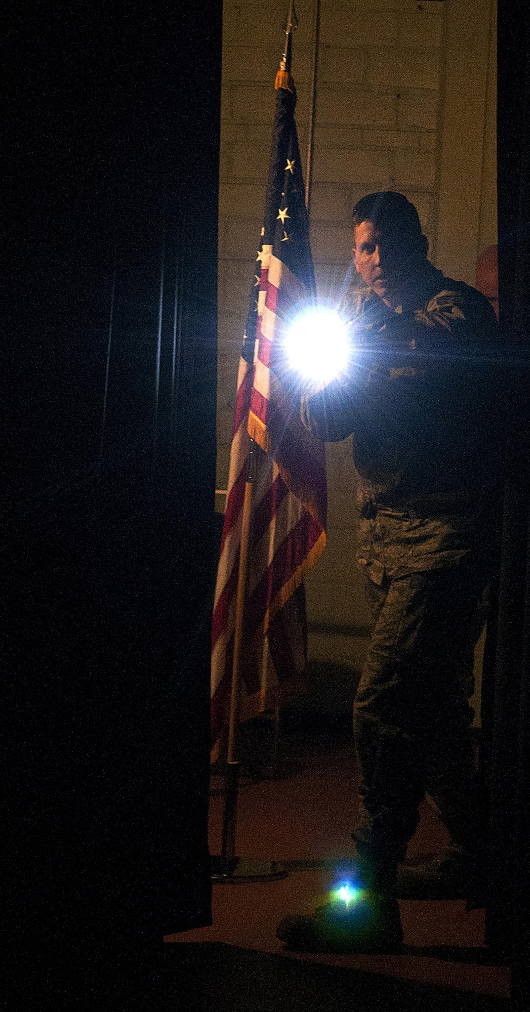 Tech. Sgt. Andrew Hogue, 90th Security Forces Squadron defender, searches the base theater on F.E. Warren Air Force Base, Wyo., during an active shooter exercise Feb. 29, 2016. Several teams coordinated their efforts to secure the facility and eliminate the opposing forces, played by volunteers. (U.S. Air Force photo by Airman 1st Class Malcolm Mayfield)