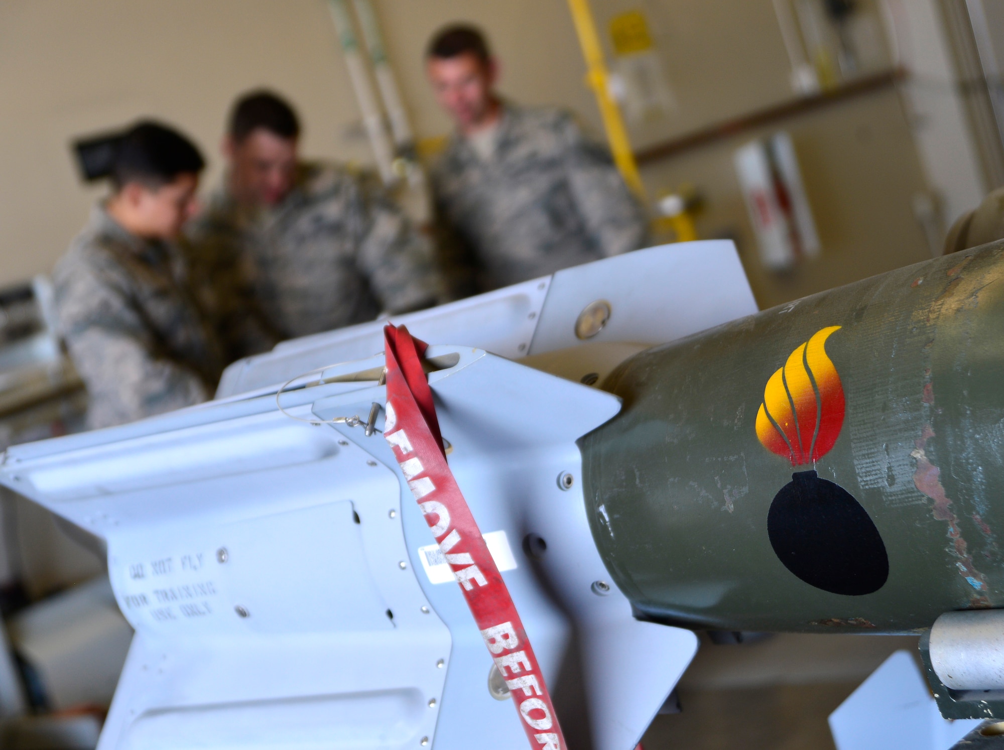 The 432nd Maintenance Squadron munitions flight reviews safety precautions before building six GBU-12 Paveway II laser-guided bombs March 1, 2016 at Creech Air Force Base, Nevada. In order to conduct a build, Airmen must be briefed on safety before the start of each operation. (U.S Air Force photo by Senior Airman Christian Clausen/Released)