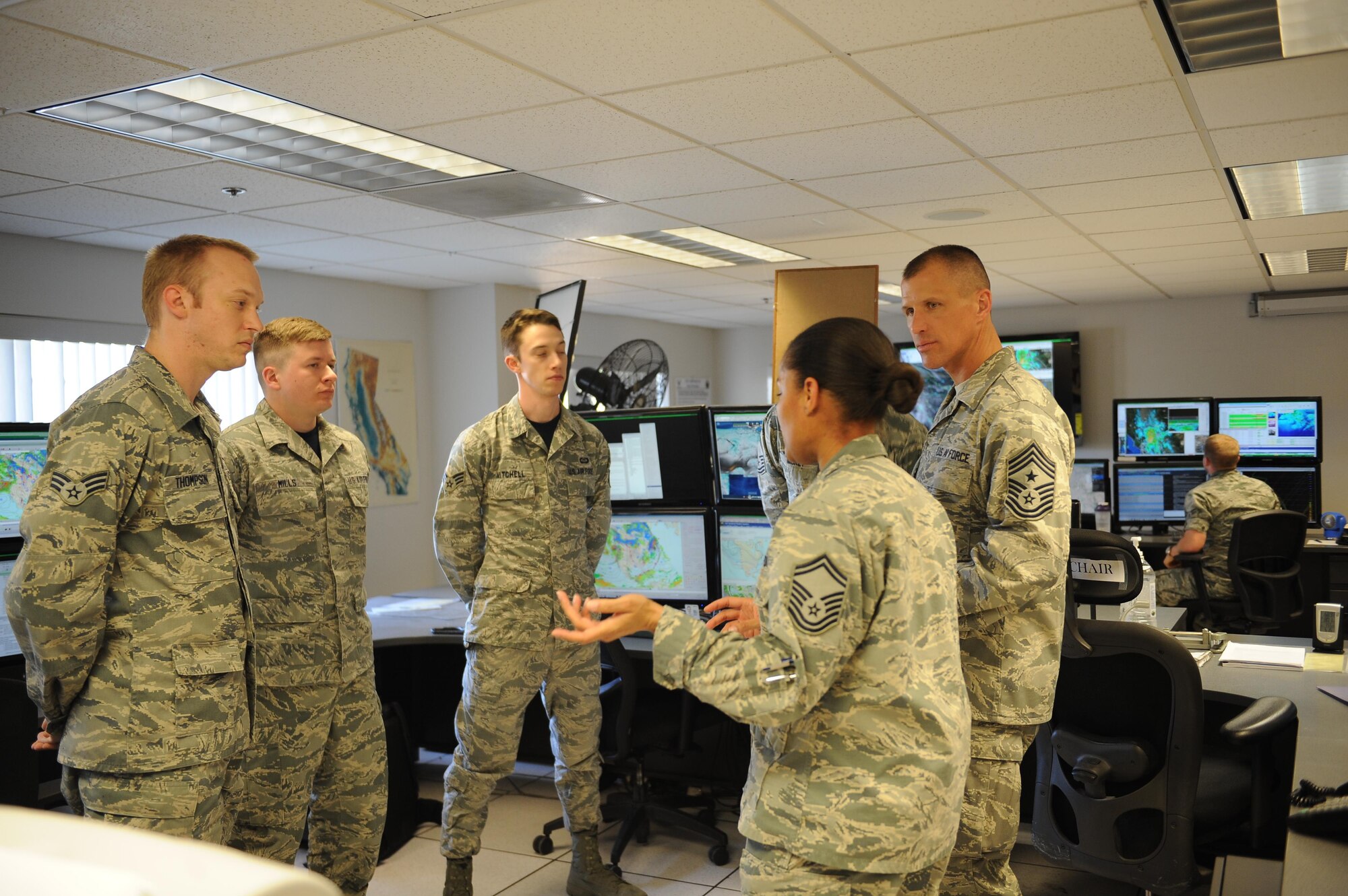 U.S Air Force Senior Master Sgt. Sharon Utsey, 25th Operation Weather Squadron operations superintendent speaks with Chief Master Sgt. Steve McDonald, Air Combat Command command chief at Davis-Monthan Air Force Base, Ariz., March 4, 2016. While touring D-M, McDonald visited the 25th OWS where he was briefed by several Airmen on the different missions within the squadron. In this section he learned how the Airman interpret data into where warn and cold fronts will be around the U.S and how it will affect the weather. (U.S. Air Force photo by Senior Airman Cheyenne A. Powers/ Released)