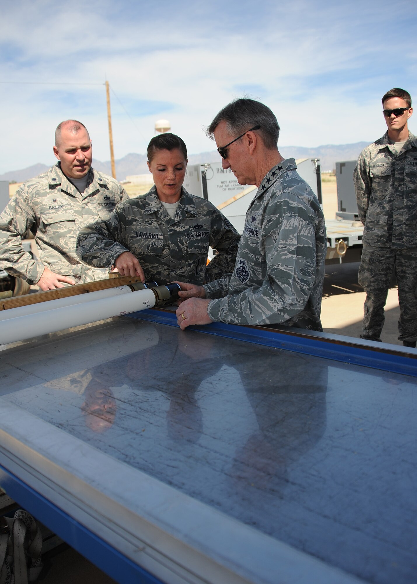 U.S. Air Force Staff Sgt. Nicole Navarro, 355th Equipment Maintenance Squadron munitions flight conventional maintenance crew chief, speaks with U.S. Air Force Gen. Hawk Carlisle, commander of Air Combat Command, at Davis-Monthan Air Force Base, Ariz., March 3, 2016. The Munitions flight provides world class support creating ammunition Davis-Monthan's A-10C Thunderbolts, C-130 Hercules and HH-60G Pave Hawks. ACC develops strategy, doctrine, concepts, tactics, and procedures for air- and space-power employment. (U.S. Air Force photo by Airman 1st Class Ashley N. Steffen/ Released)