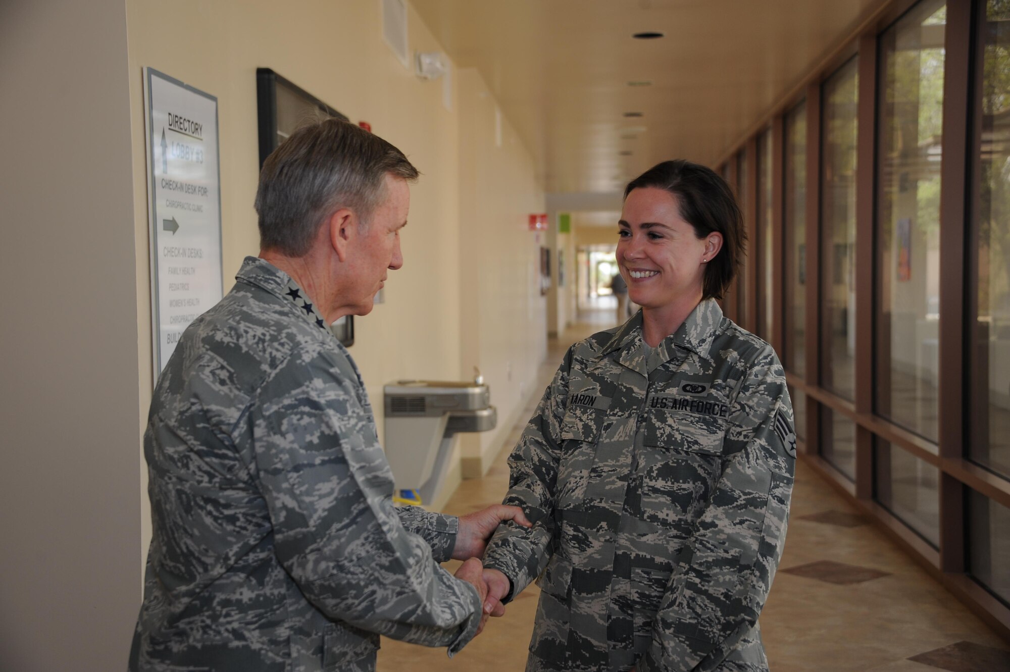 U.S. Air Force Senior Airman Laura Aaron 355th Fighter Wing Command Post emergency action controller, is coined by U.S. Air Force Gen. Hawk Carlisle, commander of Air Combat Command, at Davis-Monthan Air Force Base, Ariz., March 3, 2016. Aaron is the 355th Fighter Wing’s Airmen of the Year for 2015 and has been selected to become a commissioned officer in the U.S. Air Force. (U.S. Air Force photo by Airman 1st Class Ashley N. Steffen/ Released)