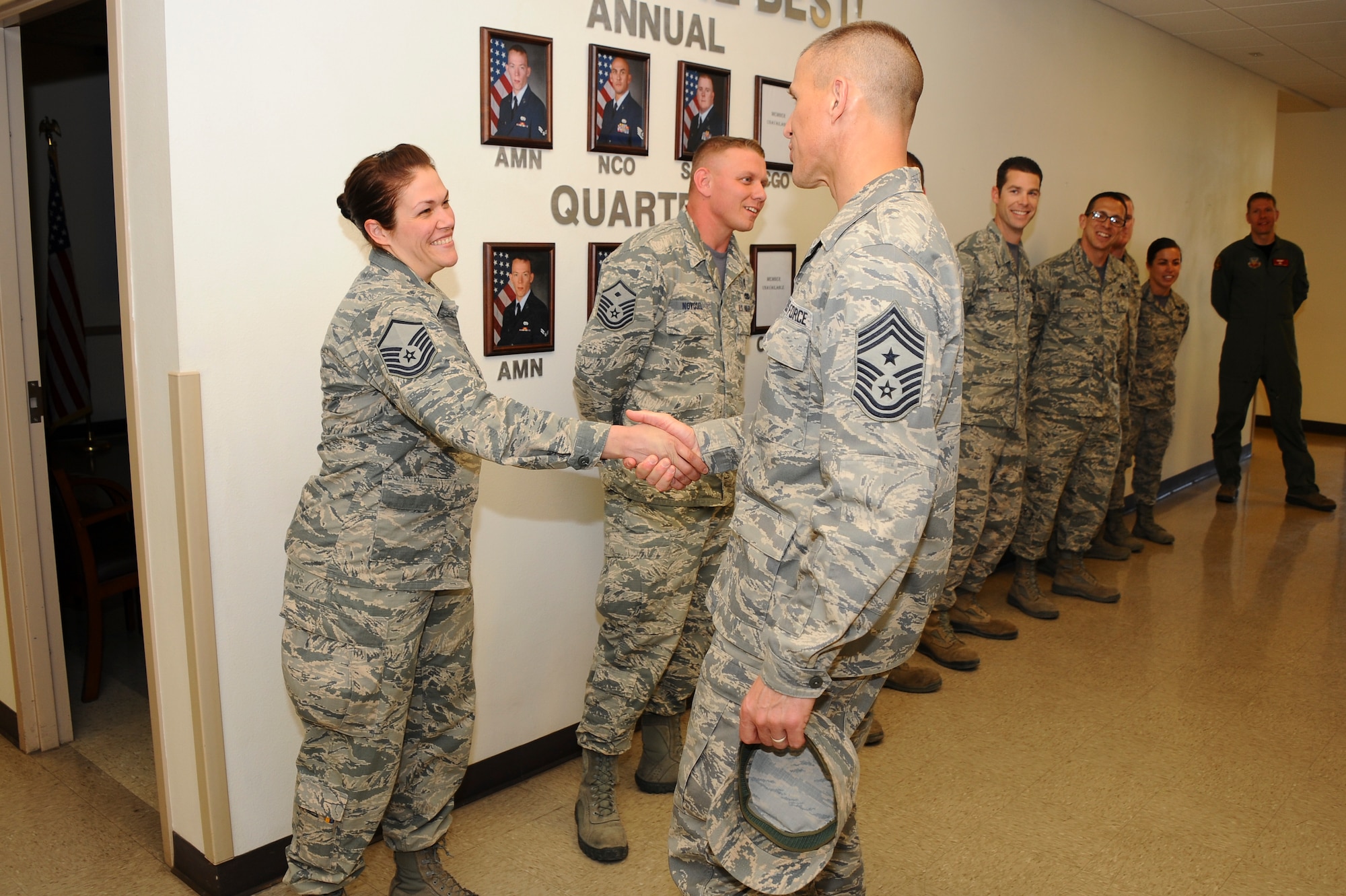 U.S. Air Force Chief Master Sergeant Steve McDonald, Air Combat Command command chief, greets Master Sergeant Rachel Lemoine, 42nd Electronic Combat Squadron simulator operations flight chief, during a base tour at Davis-Monthan Air Force Base, Ariz., March 4, 2016. The Airmen assigned to the 55th Electronic Combat Group showed McDonald around the unit and inside a EC-130H Compass Call. McDonald advises the ACC commander on mission effectiveness, professional development, military readiness, training, utilization, health, morale, and welfare of the more than 55,000 assigned enlisted personnel. (U.S. Air Force photo by Airman 1st Class Mya M. Crosby/Released)