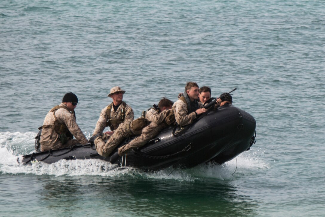 Marines with 3rd Reconnaissance Battalion demonstrate how to approach a beach in a Combat Rubber Raiding Craft during a raid to service members with the Japan Ground Self-Defense Force at Kin Blue, Okinawa, Japan, March 3, 2016. The JGSDF members watched the Marines perform raid missions and navigate using a nautical compass. The Marines are with 3rd Recon Bn., 3rd Marine Division, III Marine Expeditionary Force. (U.S. Marine photo by Cpl. Robert Williams Jr./Released)