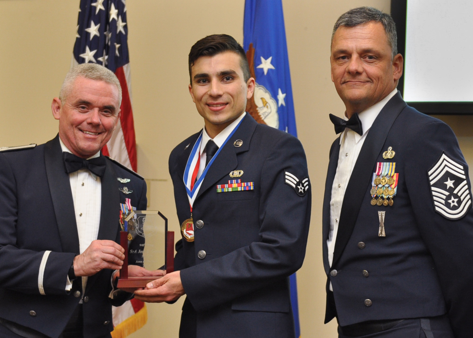 Senior Airman Jose Garcia, 701st Combat Operations Squadron, poses with Col. John Trnka, 940th Wing Commander and Chief Master Sgt. Denny Brown, 904th Wing Command Chief at the 2015 940th Wing Dining Out and Annual Awards Banquet. Garcia won the Airman of the Year annual award for standing out amongst his peers for his outstanding accomplishments throughout the year. (U.S. Air Force Photo/ Tech. Sgt. Heather Skinkle) 