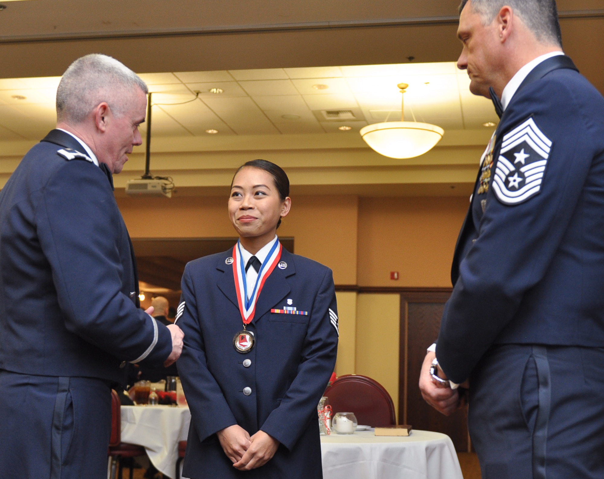 Staff Sergeant Kimheak Ly, 940th Aerospace Medicine Squadron, listens to the mentoring of Col. John Trnka, 940th Wing Commander and Chief Master Sgt. Denny Brown, 940th Wing Command Chief as an annual award nominee at the 940th Wing Dining Out and Annual Awards Banquet. The event recognized outstanding members from the 940th Wing who demonstrated superior performance throughout 2015. (U.S. Air Force Photo/ Tech. Sgt. Heather Skinkle)    