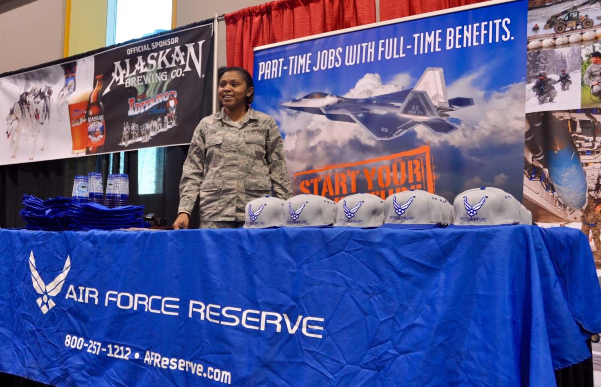 Tech. Sgt. Equallia Love, Air Force Reserve Recruiter, stands ready to discuss recruiting opportunities during social hour at the Mushers’ Banquet in Anchorage, Alaska, March 3, 2016. During the banquet, mushers pull their start numbers for the Iditarod. The Iditarod is a 1,000-mile sled dog race across the rugged terrain of Alaska. This is the second year Air Force Reserve Recruiting has sponsored the Iditarod, known as “The Last Great Race on Earth.”(U.S. Air Force/Tech. Sgt. Kimberly Moore) 