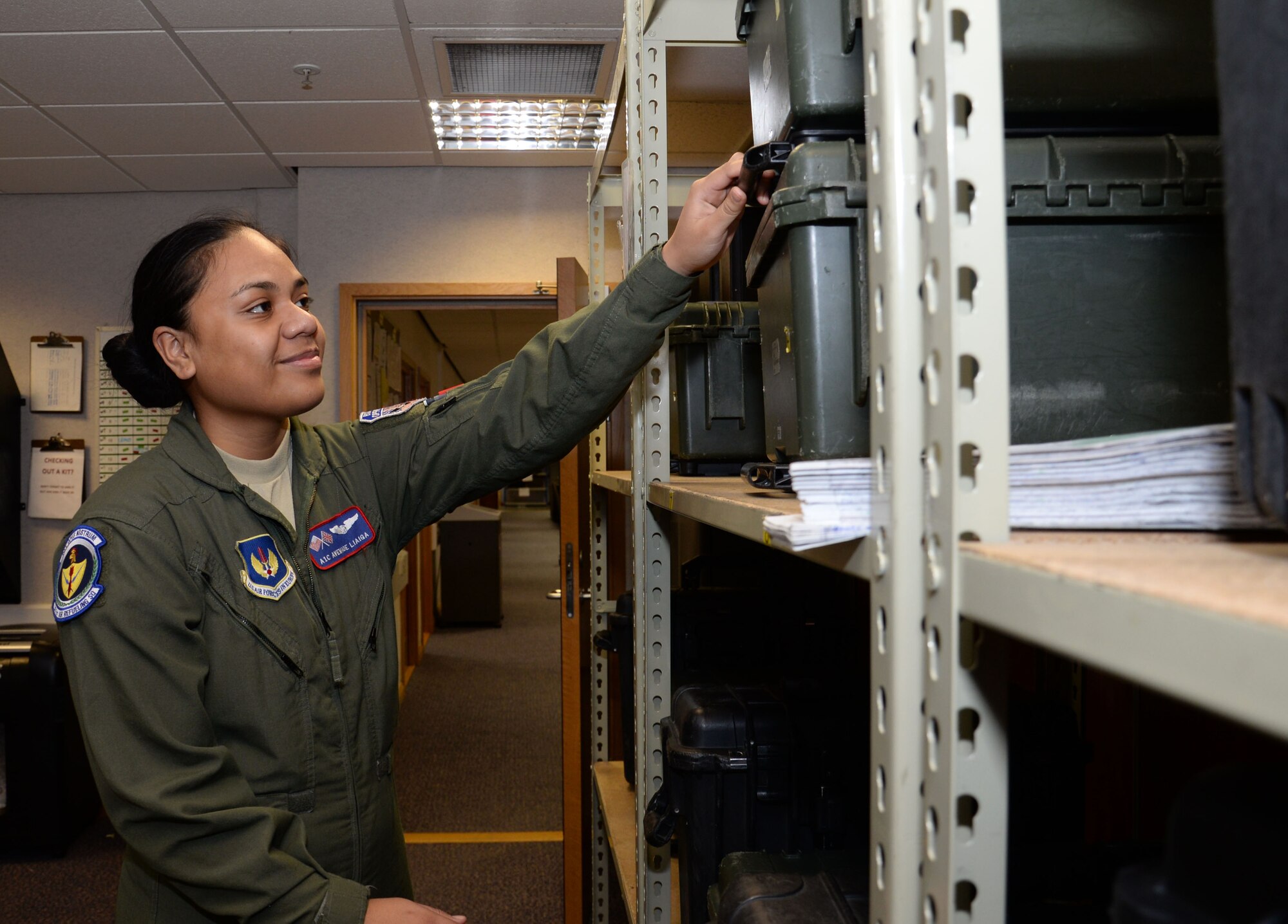 U.S. Air Force Airman 1st Class Avemaoe Liaiga, 351st Air Refueling Squadron boom operator, takes a kit box from the shelves, Feb. 25, 2016, on RAF Mildenhall, England. Boom operators have many tasks to prepare for a flight, including making sure they have all the correct equipment and receiving a mission brief from the pilot. (U.S. Air Force photo by Gina Randall/Released)