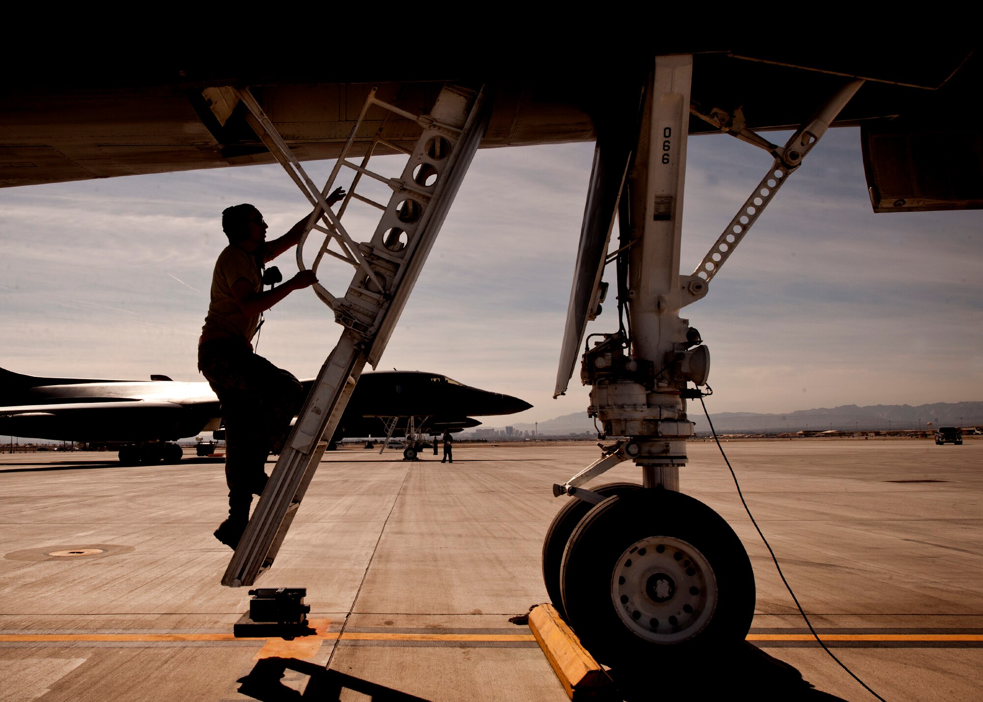An Airman assigned to the 28th Aircraft Maintenance Squadron climbs a drop-down ladder into the cockpit of a B-1 bomber to complete pre-flight checks prior to a Red Flag 16-2 training sortie at Nellis Air Force Base, Nev., March 3, 2016. High operations tempo and even higher temperatures are just two of many challenges faced by aircraft maintainers during Red Flag exercises, where consistent attention to detail is of vital importance. (U.S. Air Force photo by Senior Airman Joshua Kleinholz)