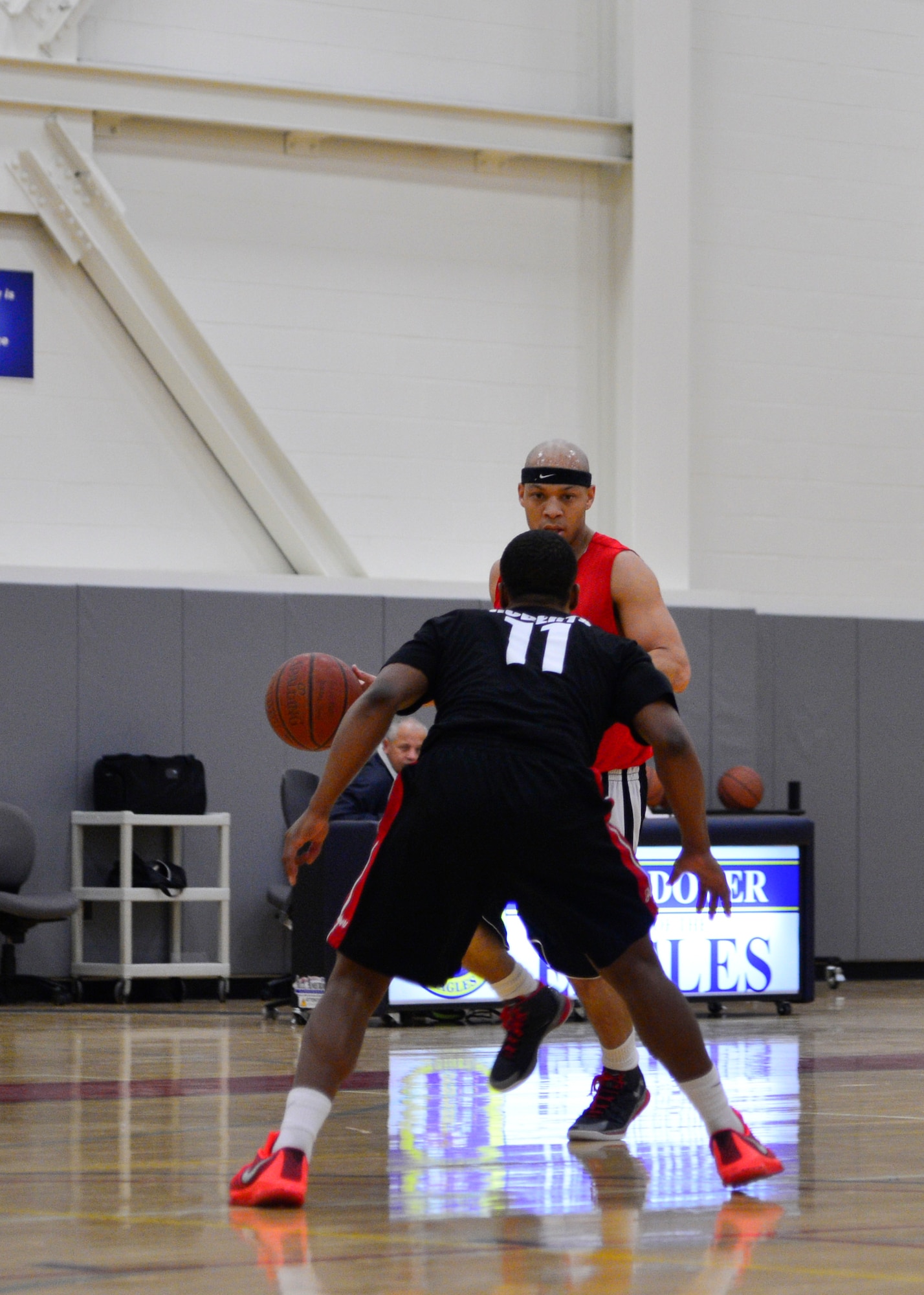 Antwan Piper, 436th Force Support Squadron/512th Airlift Wing player-coach, is guarded by Kenny Roberts, 436th Aerial Port Squadron shooting guard, during the intramural basketball championship game March 1, 2016, at the Fitness Center on Dover Air Force Base, Del. The 436th APS defeated the 436th FSS/512th AW 82-73 in overtime. (U.S. Air Force photo/Senior Airman William Johnson)